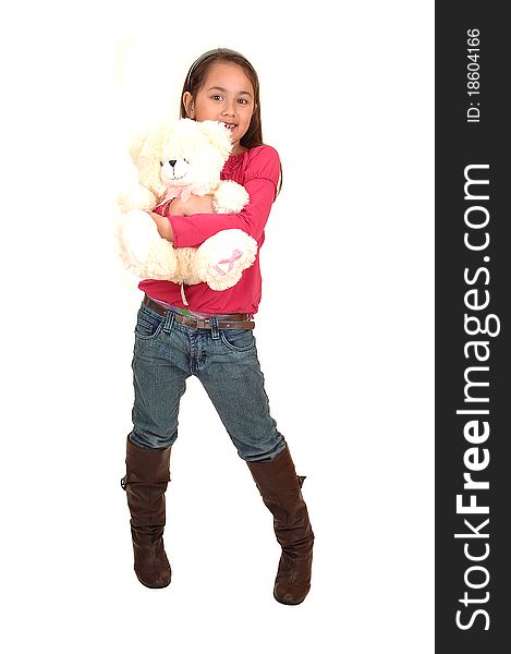 A young pretty girl standing in the studio with her white teddy bear in her arms, in jeans and boots for white background. A young pretty girl standing in the studio with her white teddy bear in her arms, in jeans and boots for white background.