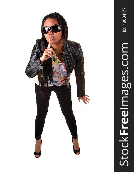 An Asian woman in a black leather jacket and tights, with sunglasses holds her finger for her mouth, be quiet, for white background. An Asian woman in a black leather jacket and tights, with sunglasses holds her finger for her mouth, be quiet, for white background.