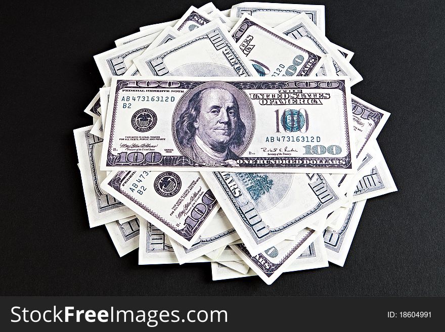 Heap of dollars on a black background