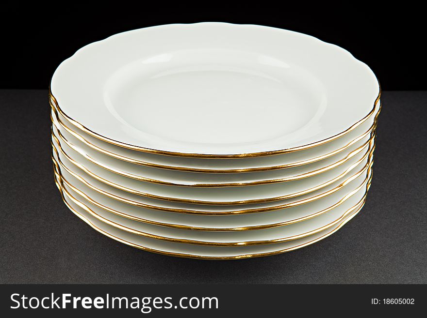 Pile of plates against a dark background