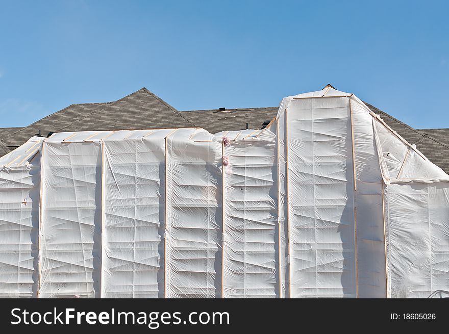 A heated plastic enclosure allows bricks to be laid during the cold winter months. A heated plastic enclosure allows bricks to be laid during the cold winter months.