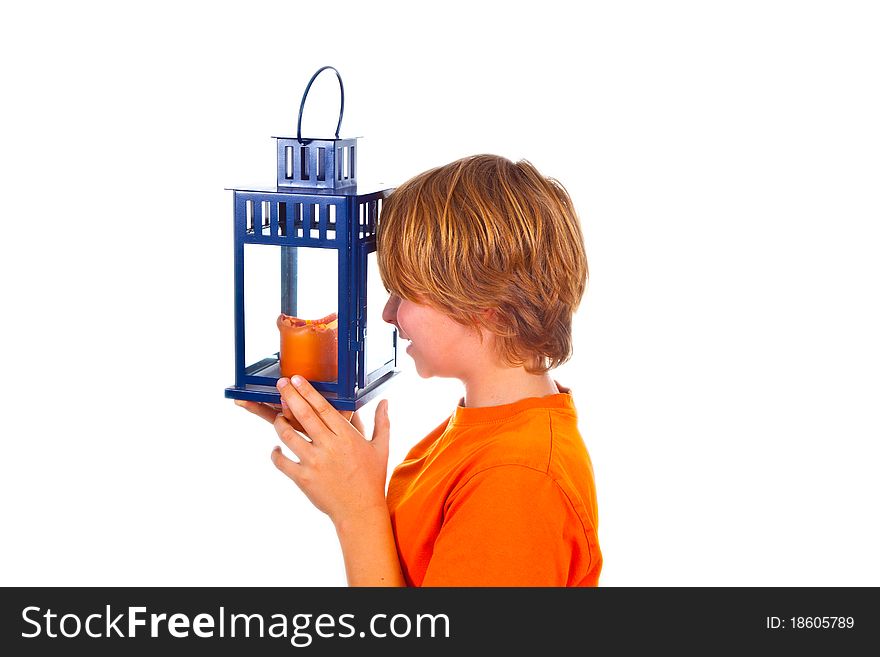 Cute boy holding a hand lantern with a candle