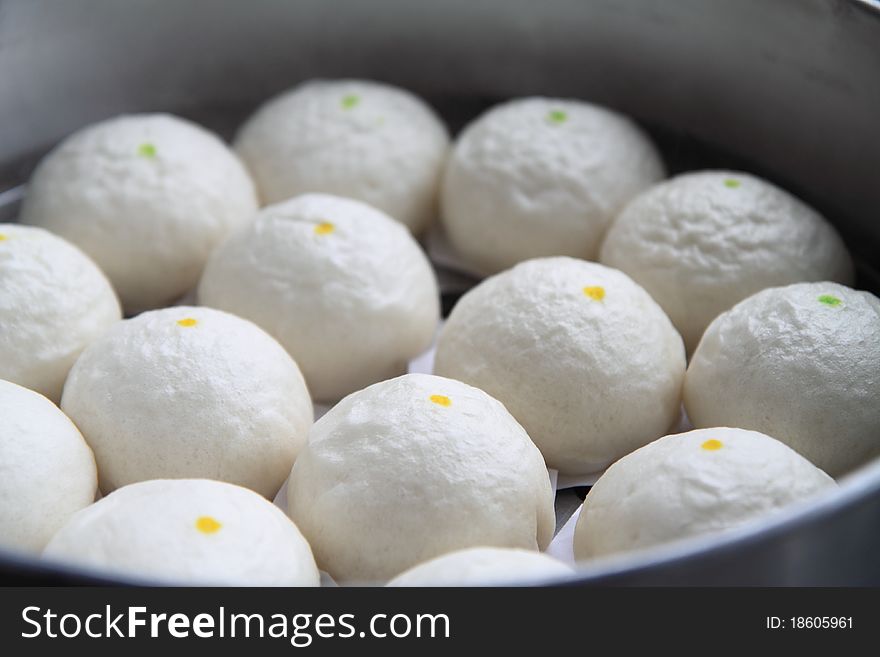 Cream buns are steamed on the stove. Cream buns are steamed on the stove.