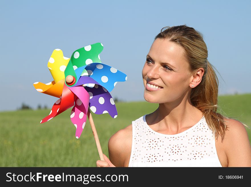 Woman on a range lan is holding wind engine. Woman on a range lan is holding wind engine