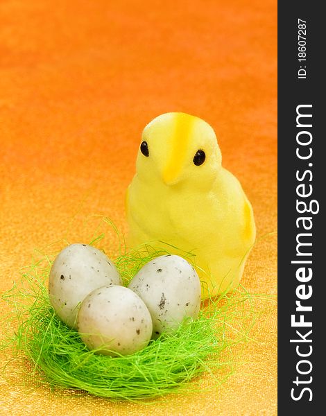 Easter chicken with spotted quail eggs on orange background. Easter chicken with spotted quail eggs on orange background