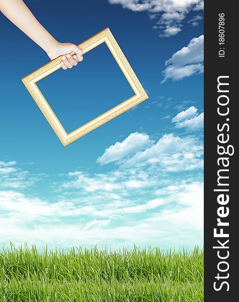 Blank Picture Frame Against Blue Sky And Green Grass. Blank Picture Frame Against Blue Sky And Green Grass
