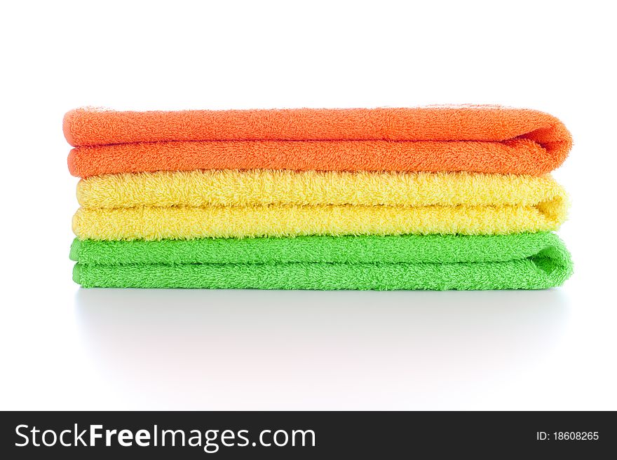Stack of fresh colorful towels isolated on white