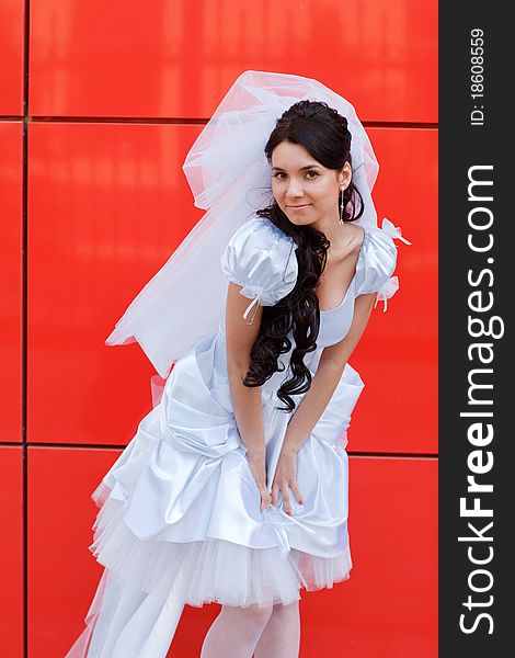 Bride by the red wall