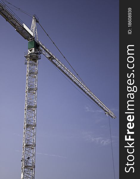 Construction cranes against the blue sky. Construction cranes against the blue sky