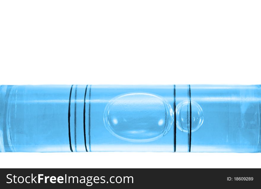 Close up on a the bubble of a blue spirit level arranged over white