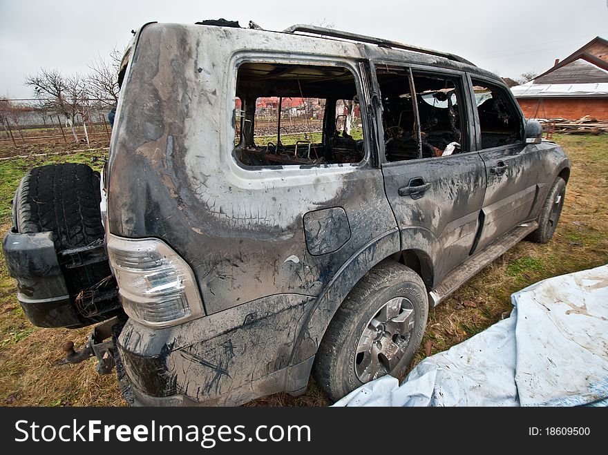 Burned car and left in a field