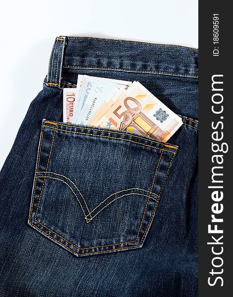 A detail of blue jeans and money