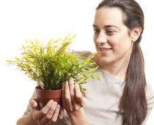 Beautiful Woman Holding A Small Plant Stock Photo