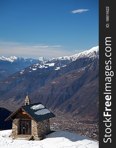 A small chapel in the mountains during winter. Mortirolo Pass, Lombardy region, Italy