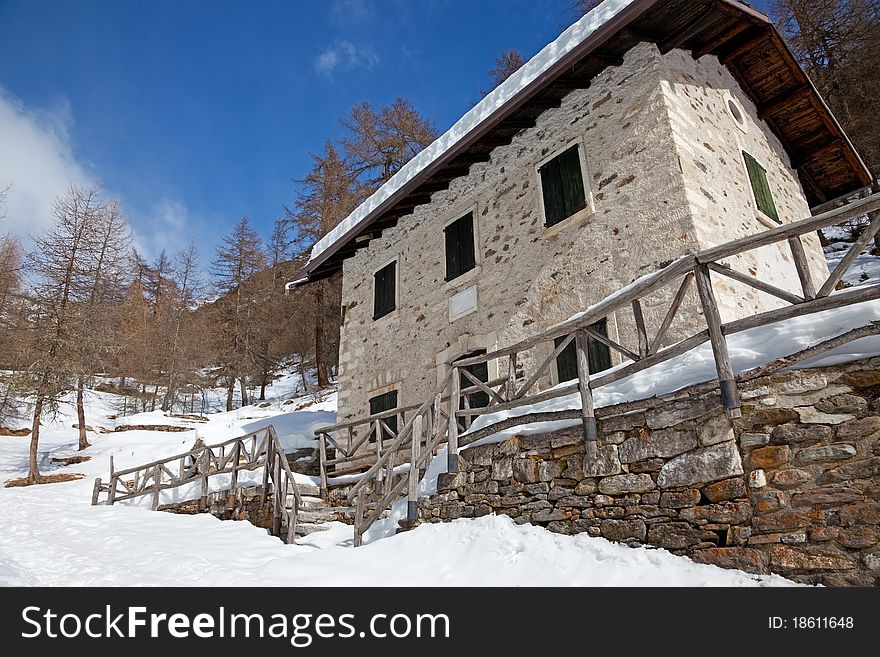 Cabin in a mountain valley in the North of Italy during winter. Brixia province, Lombardy region, Italy. Cabin in a mountain valley in the North of Italy during winter. Brixia province, Lombardy region, Italy