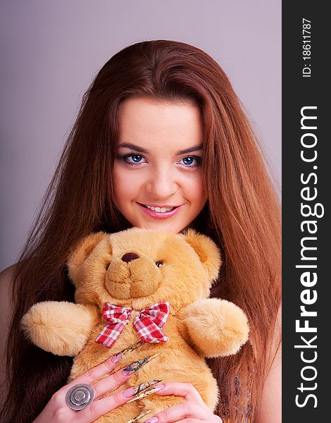 Beautiful longhair girl is holding the teddy bear. Beautiful longhair girl is holding the teddy bear