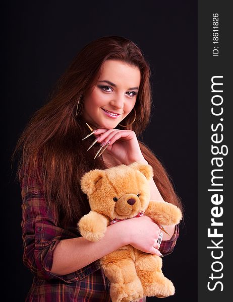 Beautiful longhair girl is holding the teddy bear. Beautiful longhair girl is holding the teddy bear