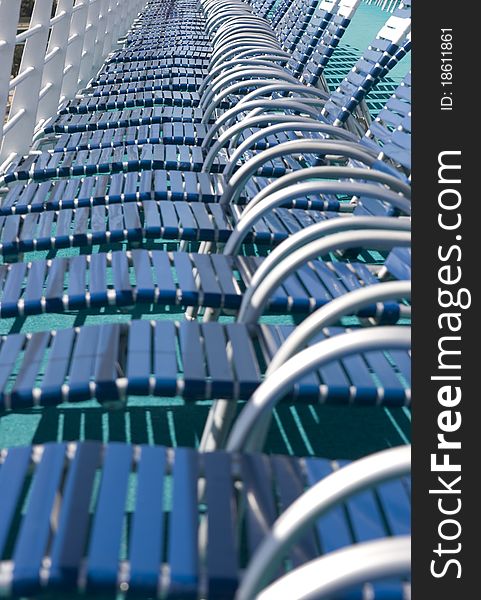 Deck chairs lined up on cruise ship.