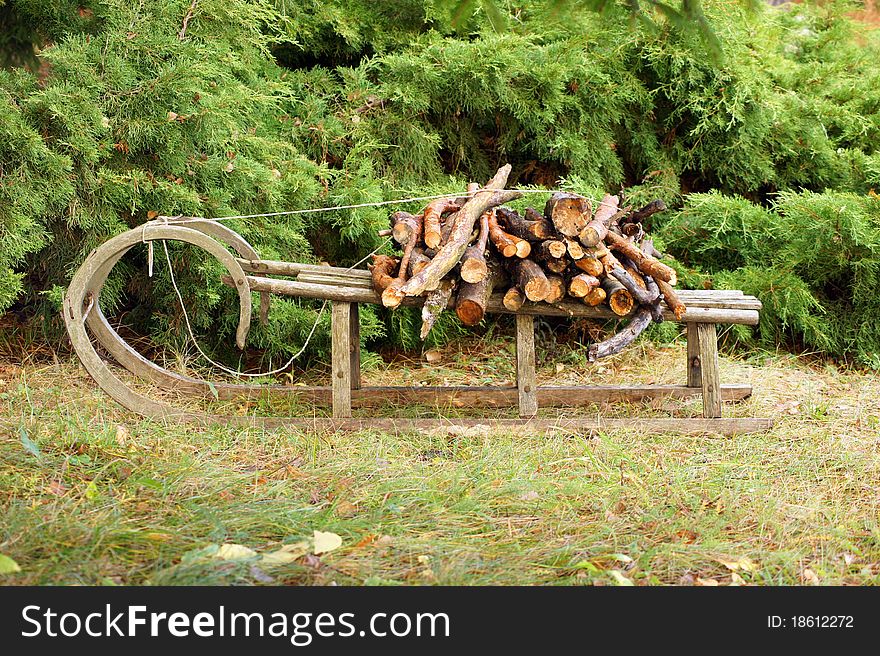 Old wooden snow sled with fire wood