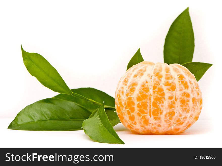 Juicy tangerine and leaves isolated on a white background.