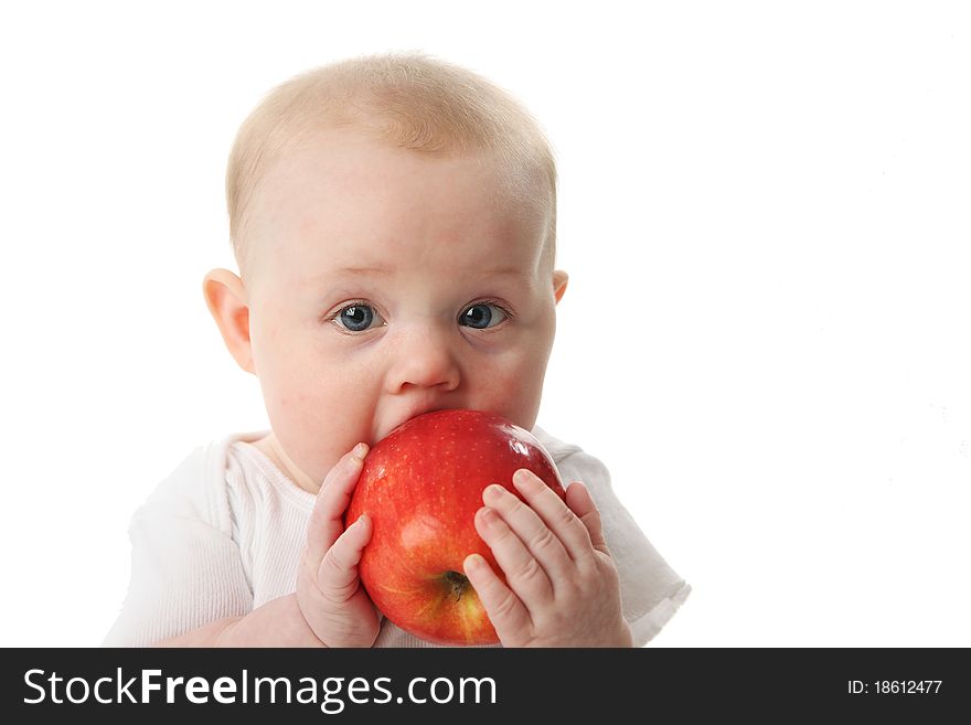 Portrait of a cute baby holding and tasting an apple. Portrait of a cute baby holding and tasting an apple