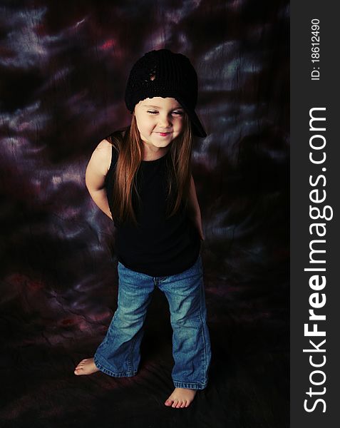 Portrait of a beautiful young female child model wearing a black crochet hat posing. Portrait of a beautiful young female child model wearing a black crochet hat posing