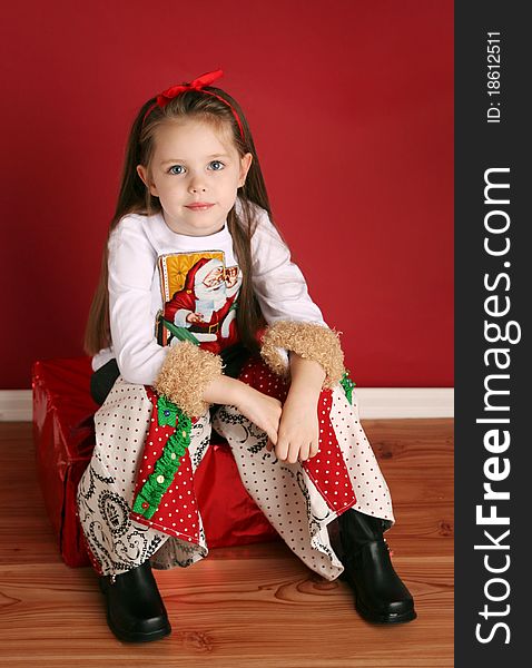 Adorable preschool girl wearing a Christmas holiday outfit posing. Adorable preschool girl wearing a Christmas holiday outfit posing