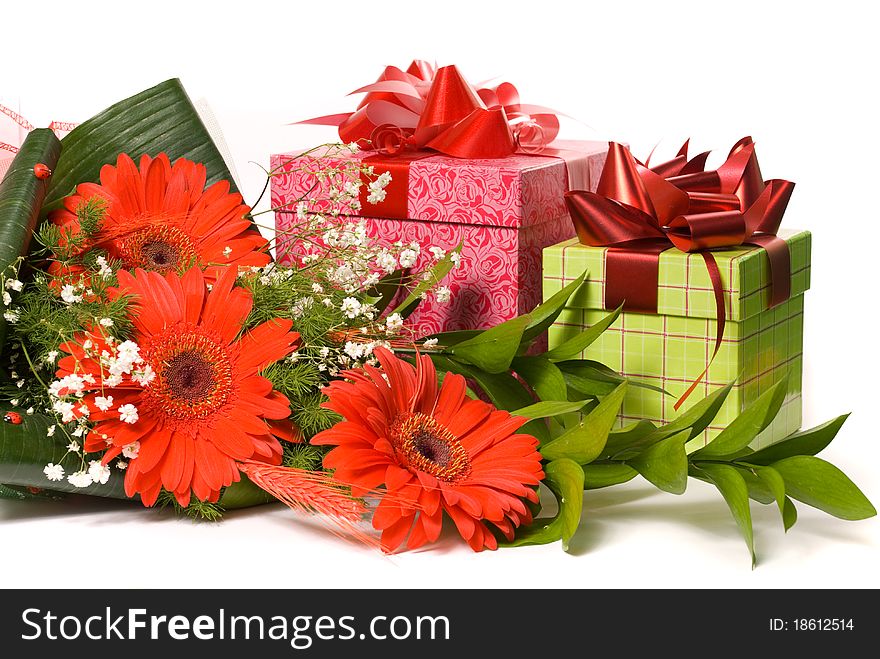Magnificent bouquet gerbera and present boxes on a white