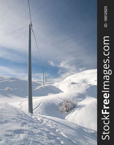 Electricity poles on the snowy mountain