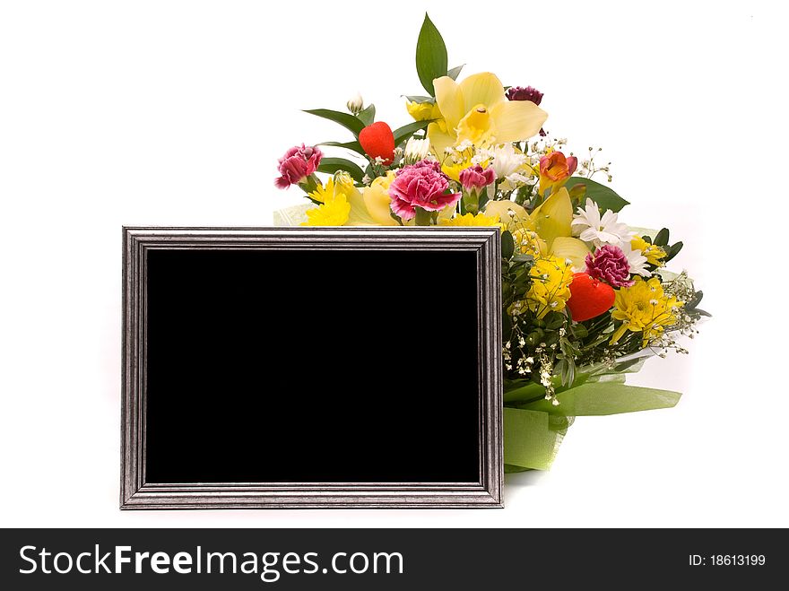 Beautiful bouquet and silver frame on a white