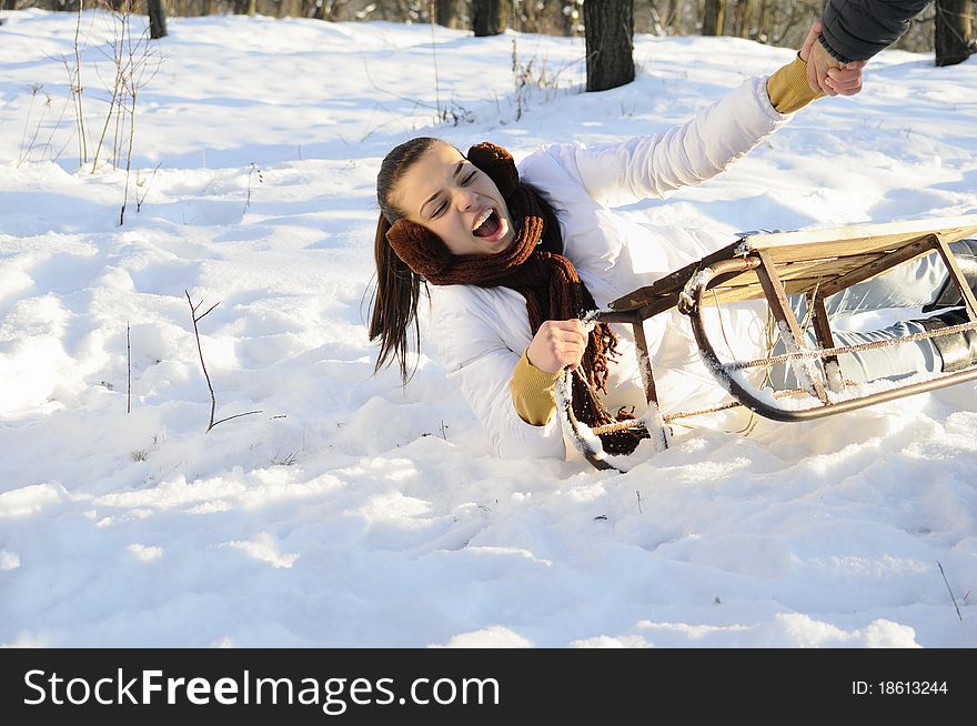 Young joyful woman having accident on sledge. Young joyful woman having accident on sledge