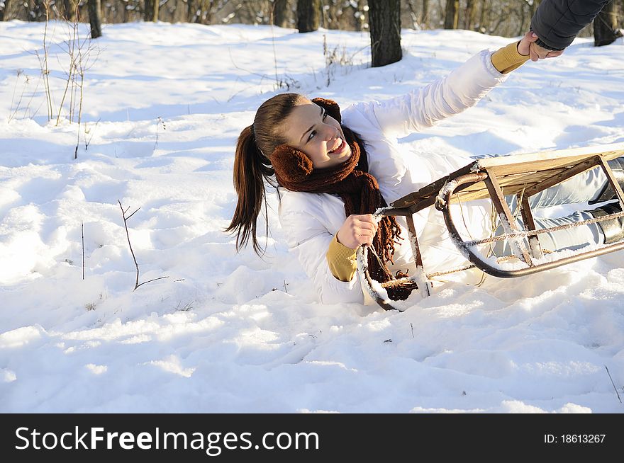 White girl having accident with sledge in winter season. White girl having accident with sledge in winter season