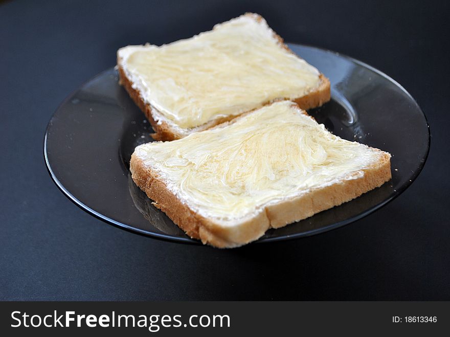 Image two slices of bread with butter and honey. Image two slices of bread with butter and honey