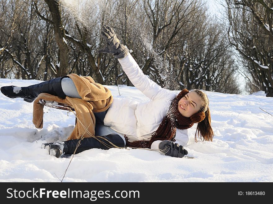 Young joyful woman fighting with snow in winter season. Young joyful woman fighting with snow in winter season