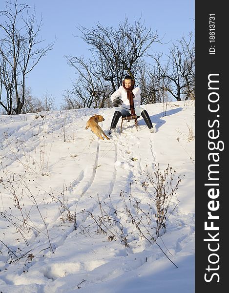 Girl playing with dog in snow