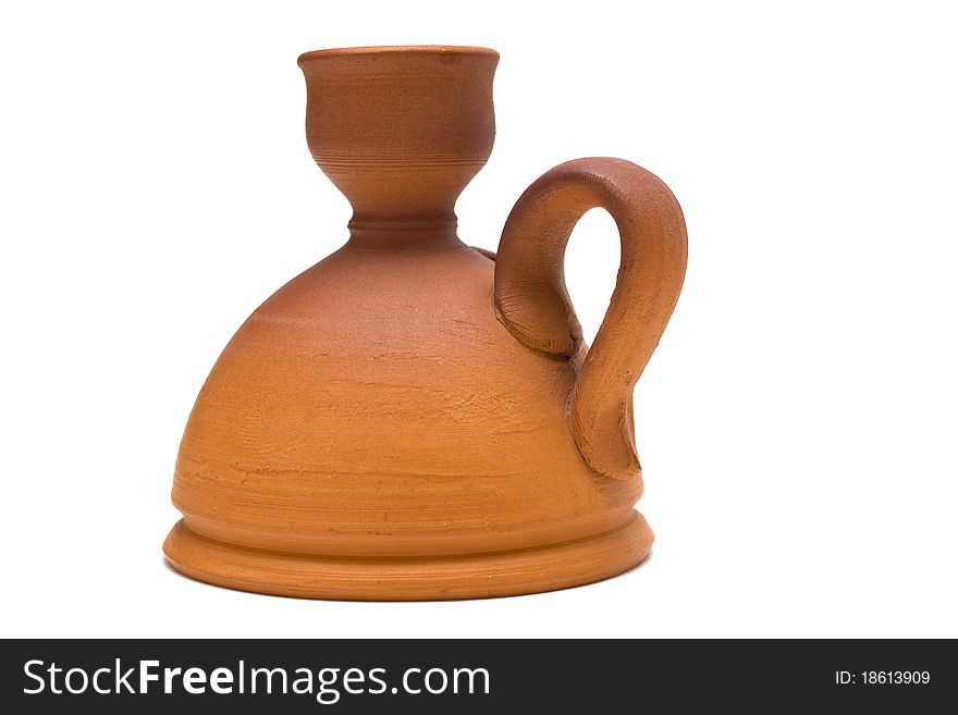 Beautiful ancient pottery candlestick on a white background. Beautiful ancient pottery candlestick on a white background