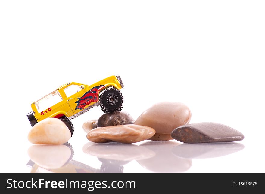 Toy Car Doing an Off-Roading Maneuver on Rocks