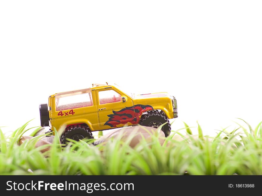 Off Roading Toy Car on Rocks and Grass