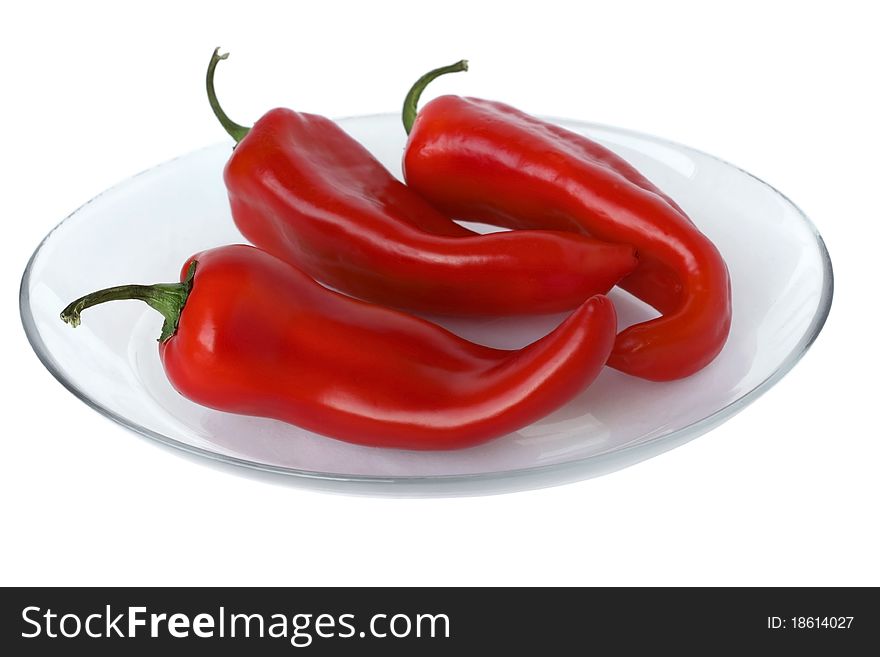 Ripe red peppers on a white background