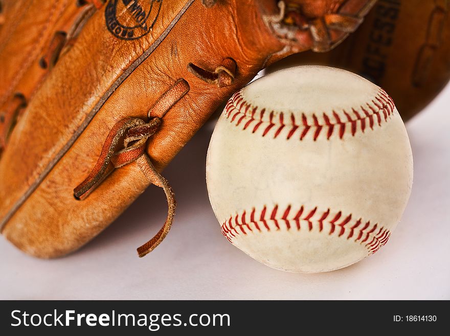 Baseball and glove with selective focus on the lacing of the glove to give depth of field; one of series in portfolio