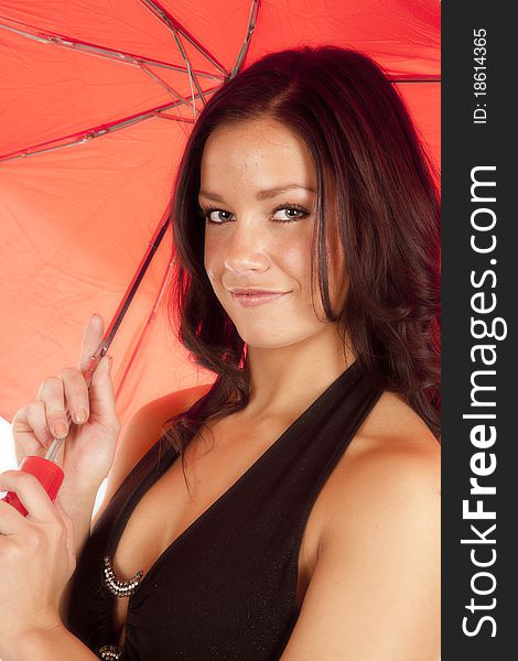 A woman is holding a red umbrella and smiling. A woman is holding a red umbrella and smiling.