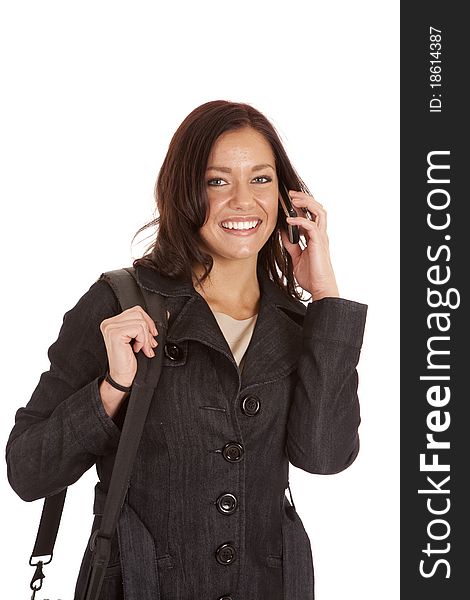 A woman in a black jacket is smiling and talking on the phone. A woman in a black jacket is smiling and talking on the phone.