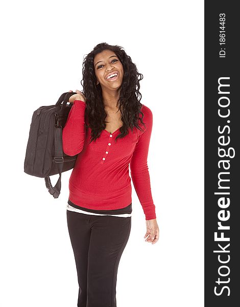 An African American woman is holding a bag over her shoulder. An African American woman is holding a bag over her shoulder.