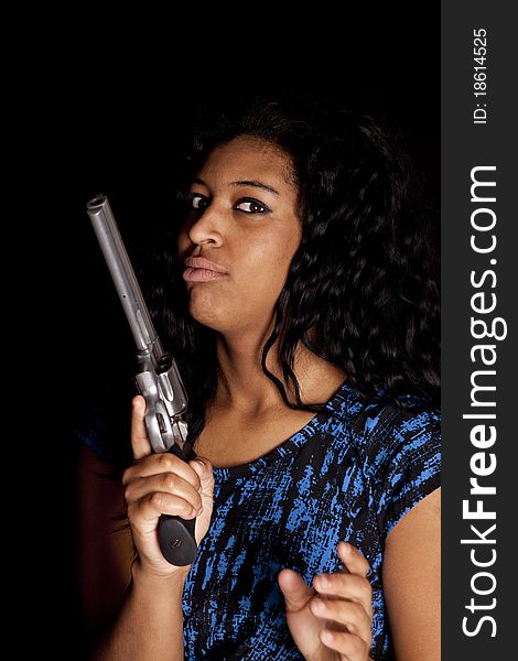 An African American woman is holding a big gun. An African American woman is holding a big gun.