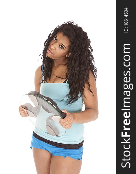 An African American woman is holding some scales. An African American woman is holding some scales.