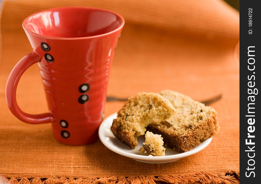 Big red cup and cake on a plate. Big red cup and cake on a plate.