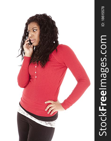 An African American is mad talking on the cell phone. An African American is mad talking on the cell phone.