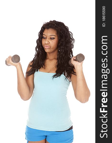 An African American woman is holding a set of weights. An African American woman is holding a set of weights.