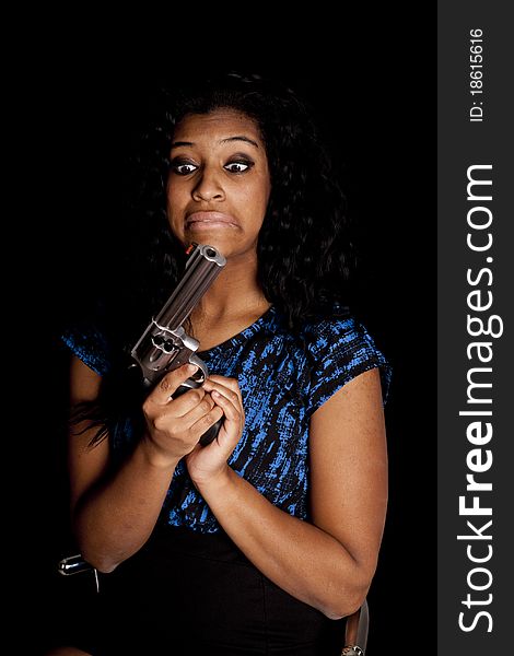 An African American has a gun and is making a funny face. An African American has a gun and is making a funny face.