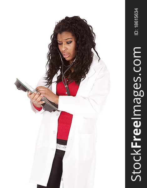 A woman doctor is listening to some scales with her stethoscope. A woman doctor is listening to some scales with her stethoscope.